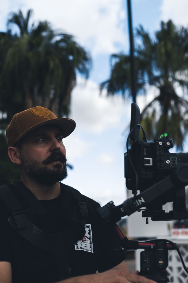 Bris.Social founder Demetri Conias on a Brisbane shoot, framing the next shot through a cinema camera.